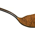 ground cinnamon in a spoon