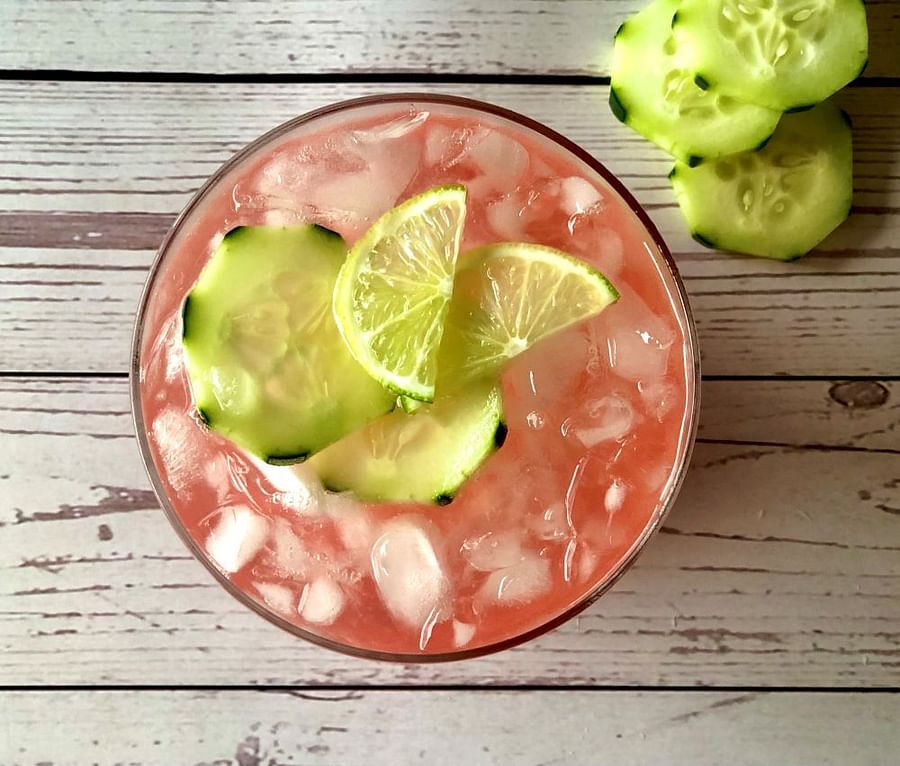 A vibrant, ruby-red strawberry mocktail in a glass