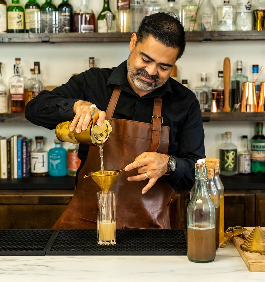 A mixologist crafting a vibrant mocktail in a Toronto bar