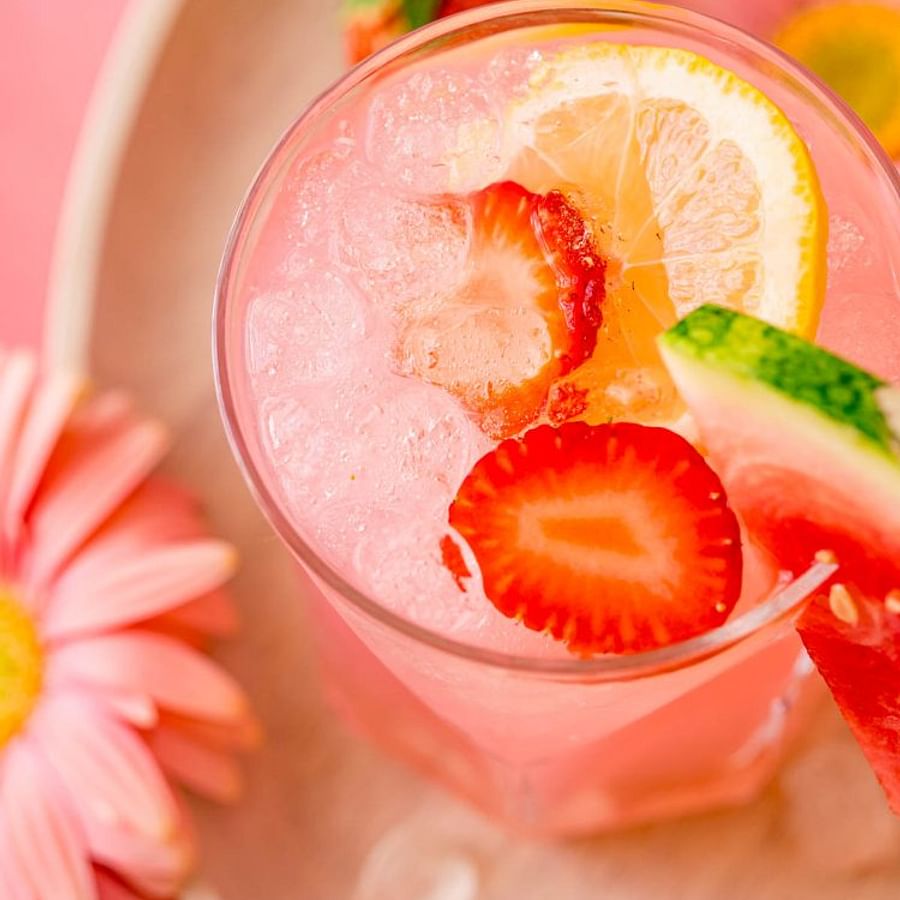 Colorful mocktail in a crystal glass garnished with fresh fruits